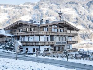 a large wooden building with snow on the ground at Farmhouse in Schwendau with Ski Storage in Hippach
