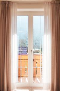 an open window with a view of a balcony at Residence Al Caminetto in Molveno