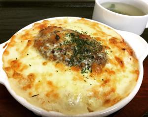 a cheese pizza sitting on a plate on a table at H-SEVEN TOYAMA (Adult Only) in Takaoka