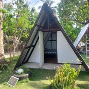 a small house with a black and white roof at 3B Beach Resort Alegria in Santa Monica