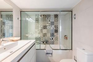 a bathroom with a shower and a toilet and a sink at Seaside Haven Central Marina Nearby Parking in Agios Nikolaos +38 photos