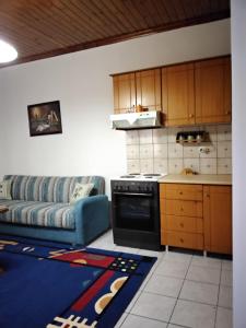 a kitchen with a couch and a stove in a room at Lambrinis house in Kanallákion