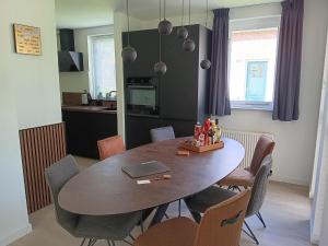 - une table à manger avec des chaises et un ordinateur portable dans l'établissement Ellen's home, à Ewijk