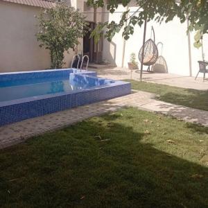 a swimming pool in the yard of a house at Чавандоz in Yakkasaray