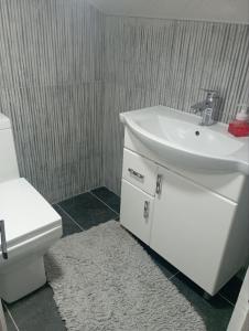 a bathroom with a white sink and a toilet at Чавандоz in Yakkasaray