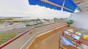 a balcony with a table and chairs and a view of the ocean at Premium Habitat Del Far in Arenys de Mar