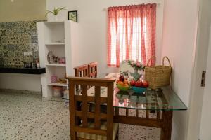 a dining room table with a bowl of fruit on it at Maya Homez - Coimbatore in Coimbatore