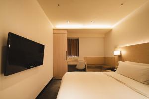 Postel nebo postele na pokoji v ubytování SWIIO Hotel Ximending