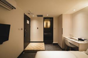 Postel nebo postele na pokoji v ubytování SWIIO Hotel Ximending
