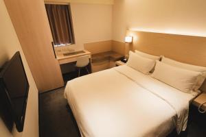 Postel nebo postele na pokoji v ubytování SWIIO Hotel Ximending