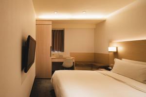 Postel nebo postele na pokoji v ubytování SWIIO Hotel Ximending