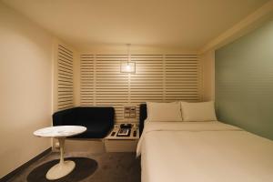 Postel nebo postele na pokoji v ubytování SWIIO Hotel Ximending