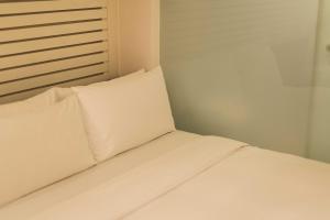 Postel nebo postele na pokoji v ubytování SWIIO Hotel Ximending