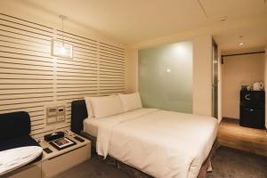 Postel nebo postele na pokoji v ubytování SWIIO Hotel Ximending