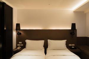 Postel nebo postele na pokoji v ubytování SWIIO Hotel Ximending