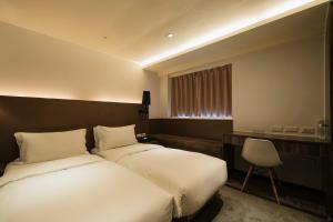 Postel nebo postele na pokoji v ubytování SWIIO Hotel Ximending