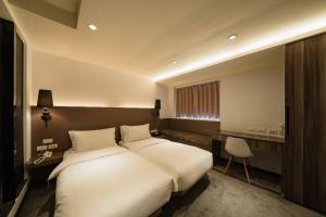 Postel nebo postele na pokoji v ubytování SWIIO Hotel Ximending