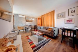 a living room with a couch and a table at Sunčica in Velika Gorica