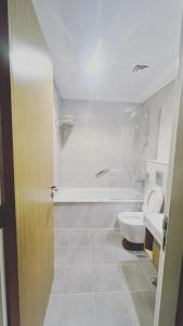 a bathroom with a toilet and a bath tub at Burj al arab and seaview in Dubai
