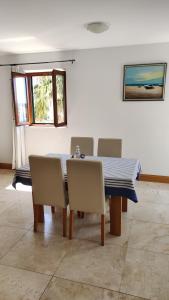 a dining room with a blue table and chairs at Apartman Linda in Milna