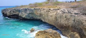 a large cave in the side of a cliff at villa nikiboko Bonaire in Kralendijk