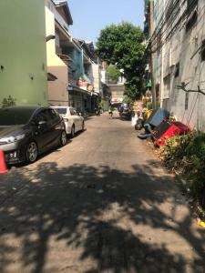 eine Straße mit am Straßenrand geparkt in der Unterkunft Orchid House in Bangkok