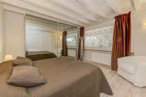 Postel nebo postele na pokoji v ubytování Ca Rossa Ibisco by Garda FeWo