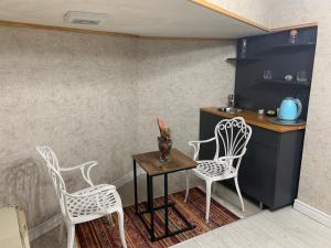 a small kitchen with two chairs and a table at Valeria House in Istanbul