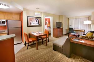 a hotel room with a kitchen and a living room at Residence Inn by Marriott Calgary Airport in Calgary