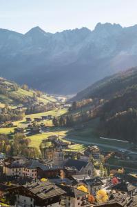 a town in a valley with mountains in the background at Le Roc Des Tours in Le Grand-Bornand