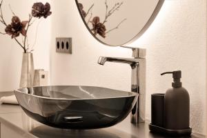 a bathroom sink with a black bowl bowl sink at Refugio in Sittersdorf