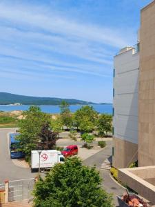 a view of a parking lot with a building at Апартамент БОХО Приморско in Primorsko +5 photos