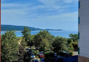 a view of a parking lot next to the water at Апартамент БОХО Приморско in Primorsko