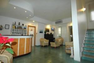 a lobby with a bar and chairs and a living room at Hotel Mayor in Sperlonga