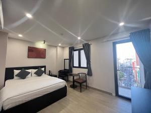 a bedroom with a bed and a large window at G Hotel Sai Gon in Ho Chi Minh City