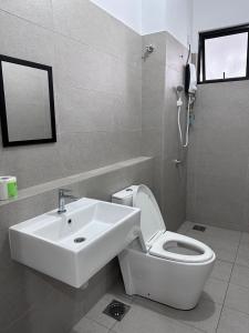 La salle de bains blanche est pourvue d'un lavabo et de toilettes. dans l'établissement 55 Cozy Home Mount Austin Eco Adda Setia Indah Daya, à Johor Bahru
