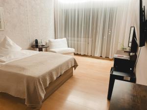 Postel nebo postele na pokoji v ubytování Hotel Harzer am Kurpark