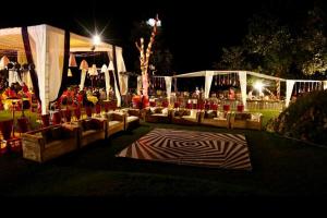 a group of couches sitting in a field at night at The Mountain Quail in Mussoorie