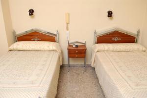 En eller flere senge i et værelse på Hotel Borja