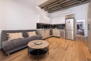 a living room with a couch and a table at Kimia Luxury Apartments in Kolymbia