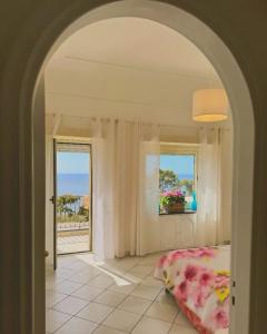 a bedroom with a bed and a view of the ocean at Villa Azul in Anacapri