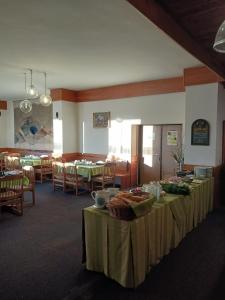 a dining room with tables and chairs and tablesktop at Hotel Albert in Paseky nad Jizerou