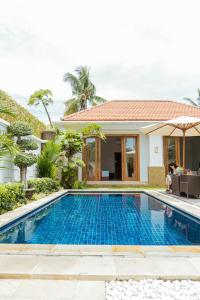 a swimming pool in front of a villa at Villa Nugraha Lovina Private Pool in Singaraja