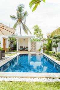 a swimming pool in the backyard of a villa at Villa Nugraha Lovina Private Pool in Singaraja