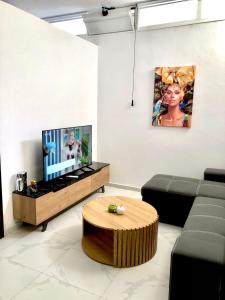 a living room with a couch and a flat screen tv at Chrysa- Kyra Apartments in Heraklio Town