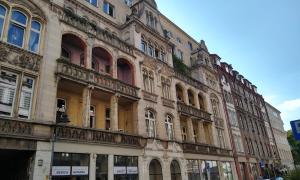 a large building with lots of windows on a street at AlmaOldTown - Centrum - Check-In 24h in Wrocław