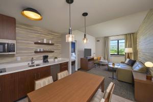 a kitchen and living room with a dining room at Residence Inn by Marriott Oahu Kapolei in Kapolei