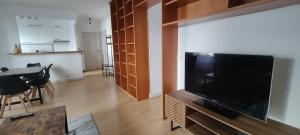 een woonkamer met een grote flatscreen-tv bij Appartement Cosy Suresnes in Suresnes