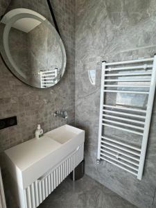 a bathroom with a white sink and a mirror at MyBlueVista LUXURY WELLNESS VILLA La Mer NEAR MONACO in Roquebrune-Cap-Martin