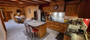 a kitchen with a counter and a table in a room at La Forge du Rosay in Viry